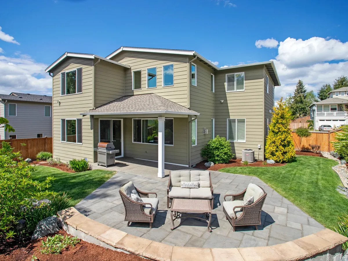 Family backyard with stone patio and lawn
